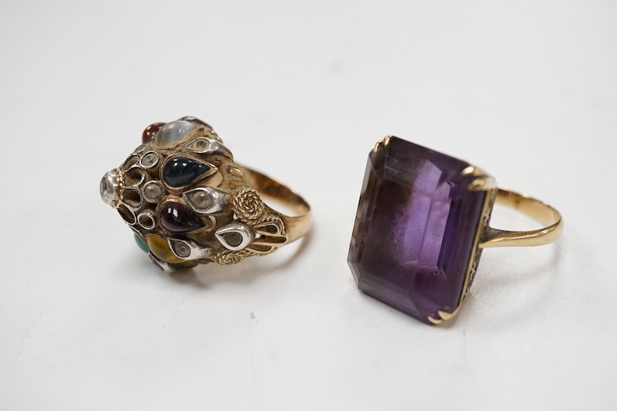 A yellow metal and single stone emerald cut amethyst set dress ring, size Nm together with an Indian? yellow metal and multi gem set ring.